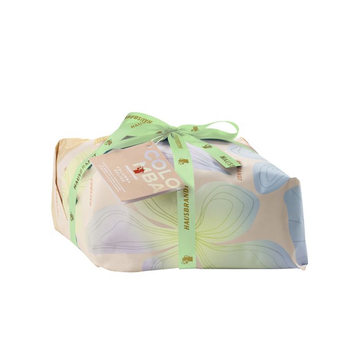 Panettone artigianale incartato con nastro verde e carta floreale, perfetto per regali gourmet.